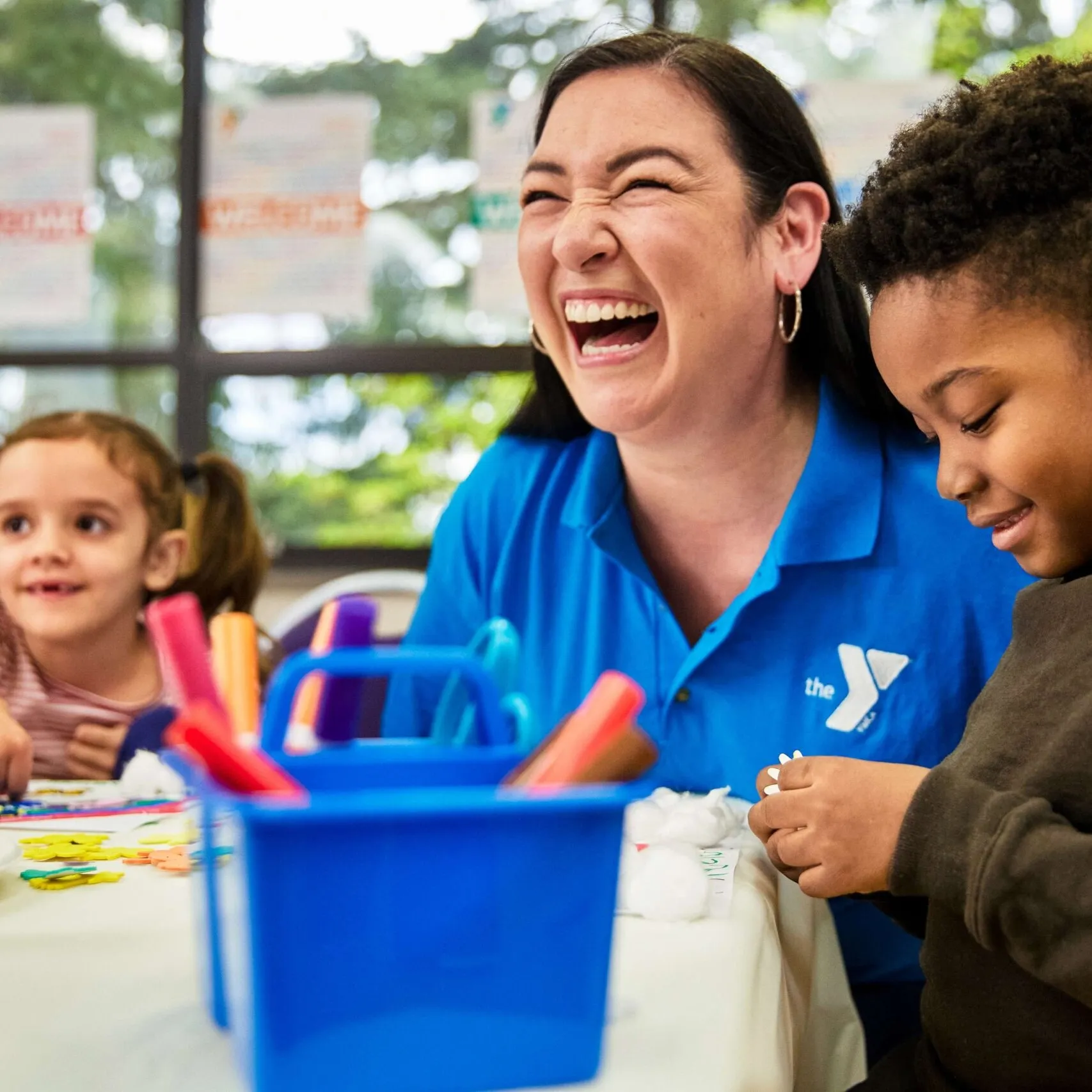 afterschool staff member with young kids